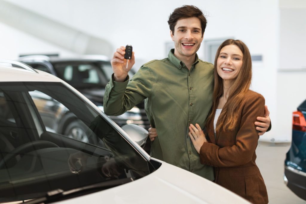 a young and happy couple bought a new car