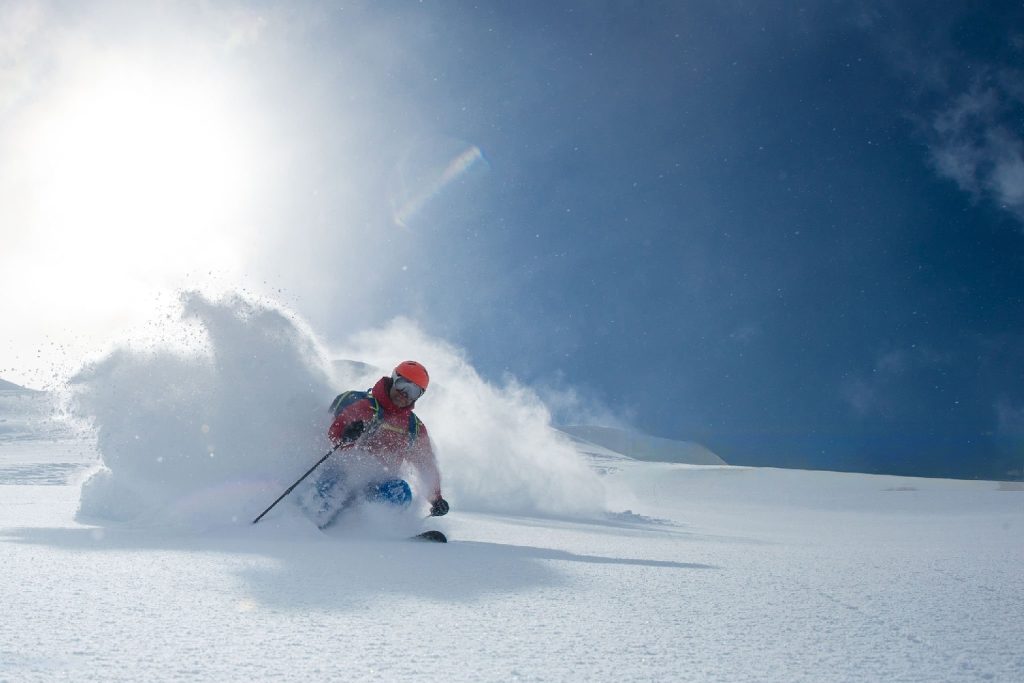 skier skiing on powdery snowfields