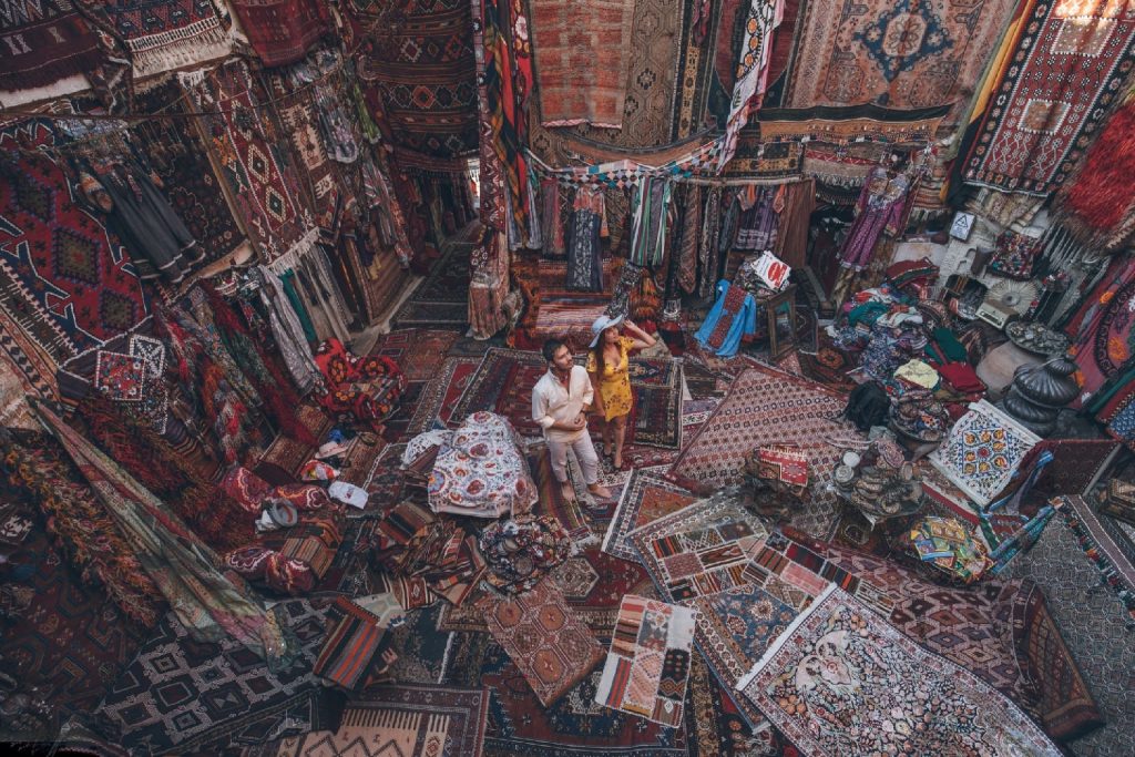 couple looking at carpets in different style and colors