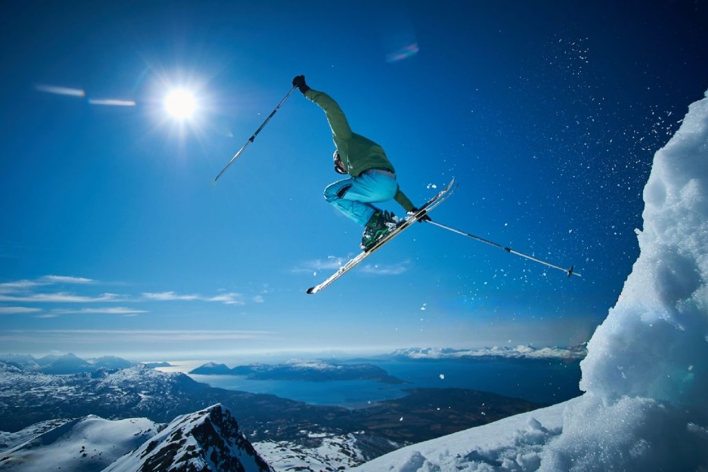ski expert performing freestyle in mountains