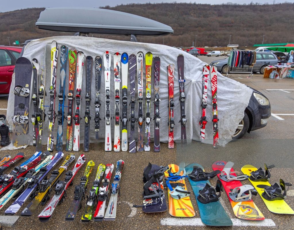 different styles, colors and sizes skis placed on roadside