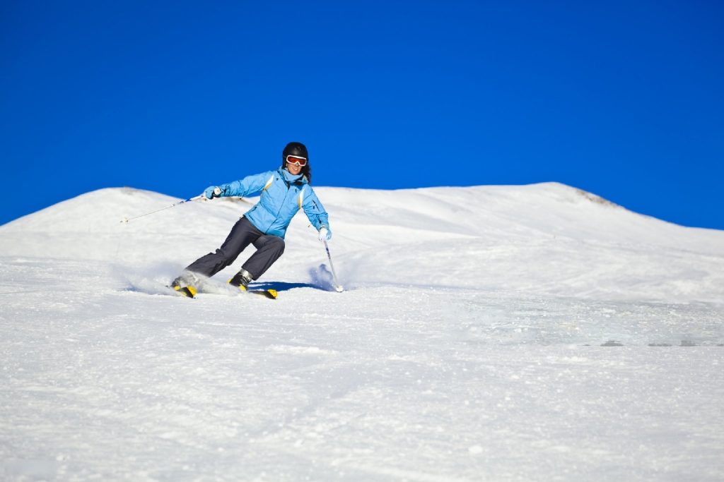 skier carving in snowfields
