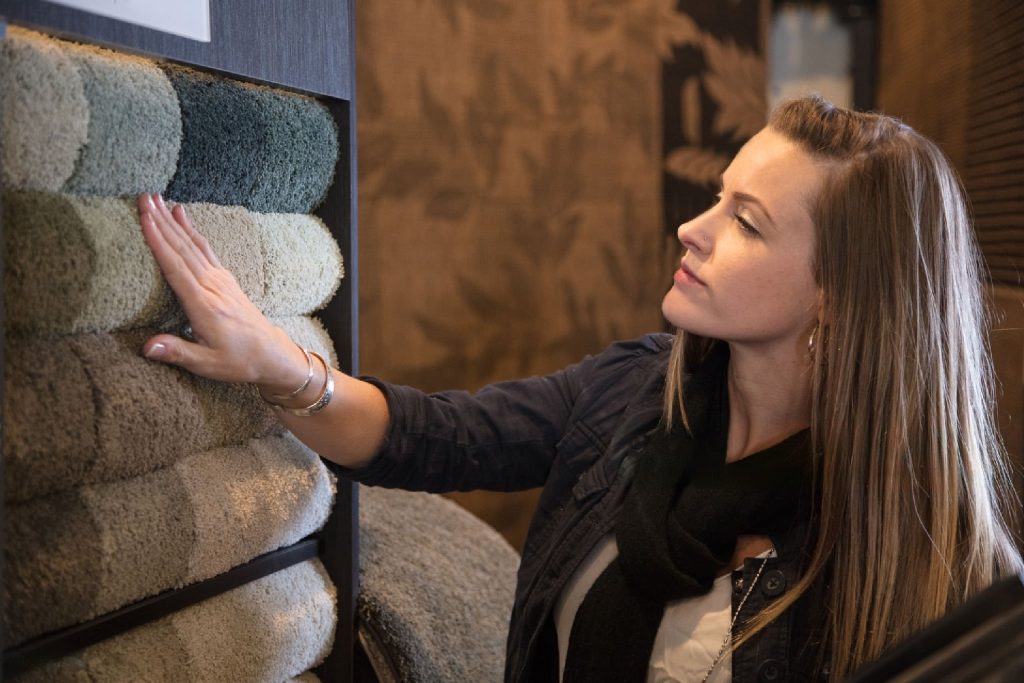 woman looking at carpet texture