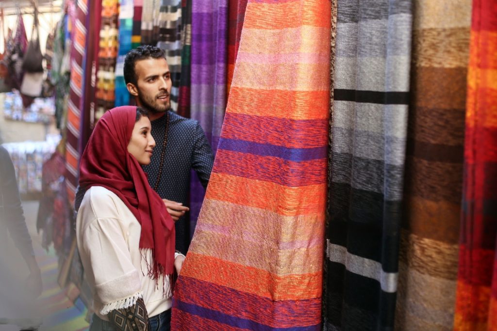 couple selecting a carpet in market