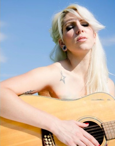 girl holding acoustic guitar