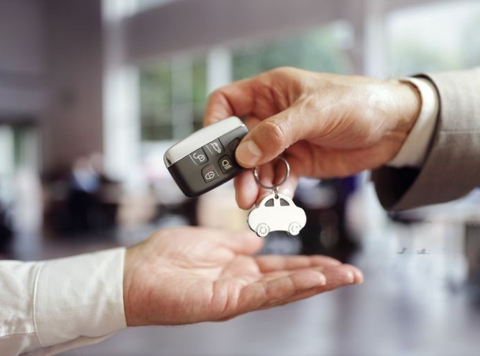 old man handing over car key