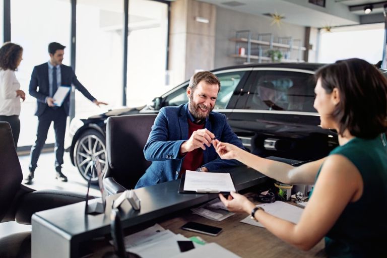man getting car keys after lease contract