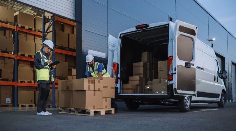 two men packing and loading delivery packages